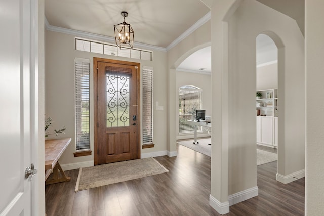 14208 Lucille Dr, Newark, TX 76071 - foyer entrance featuring arched walkways, dark wood-style flooring, ornamental molding, a chandelier, and baseboards