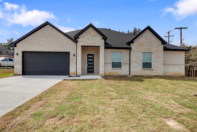 2217 S Peachtree Ct, Denison, TX 75020 - view of front of home featuring stone siding, an attached garage, concrete driveway, and a front lawn