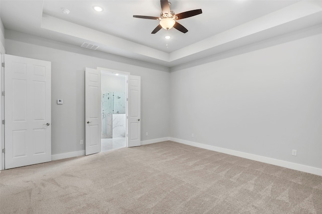 2217 S Peachtree Ct, Denison, TX 75020 - unfurnished bedroom with carpet flooring, baseboards, a raised ceiling, recessed lighting, and ensuite bathroom