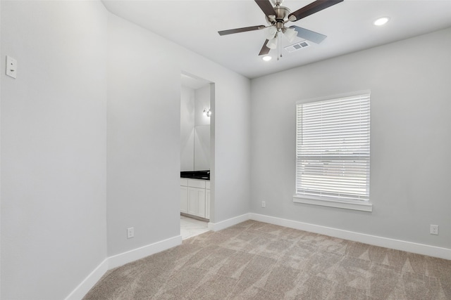 2217 S Peachtree Ct, Denison, TX 75020 - spare room featuring light colored carpet, baseboards, a ceiling fan, and recessed lighting