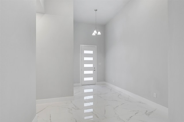 2217 S Peachtree Ct, Denison, TX 75020 - entryway featuring light marble finish floors, a chandelier, and baseboards