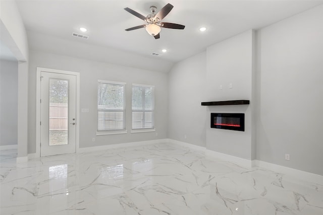 2217 S Peachtree Ct, Denison, TX 75020 - unfurnished living room with healthy amount of natural light, a glass covered fireplace, ceiling fan, baseboards, and lofted ceiling