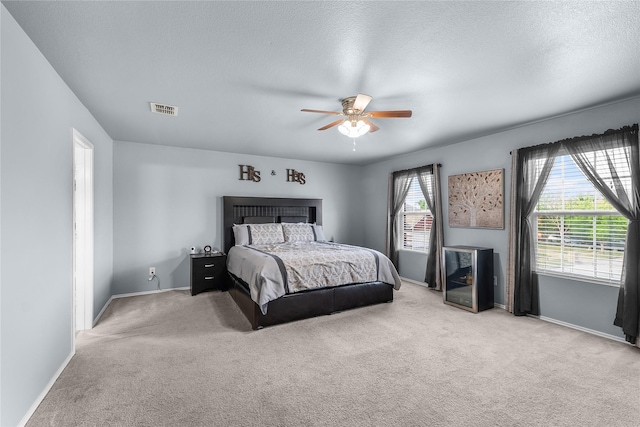 8002 Stowe Springs Ln, Arlington, TX 76002 - bedroom featuring light carpet, baseboards, a ceiling fan, and a textured ceiling