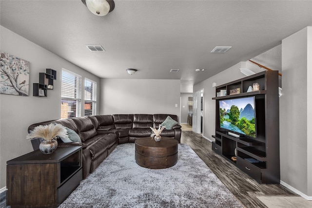8002 Stowe Springs Ln, Arlington, TX 76002 - living room featuring dark wood finished floors, baseboards, and a textured ceiling