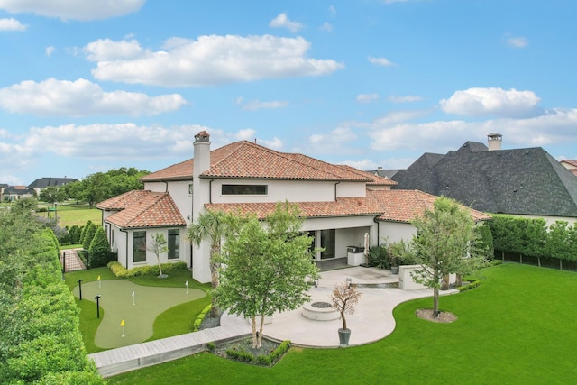 12310 Harvest Meadow Dr, Frisco, TX 75033 - rear view of property with an area to practice putting, a patio, stucco siding, and a tiled roof