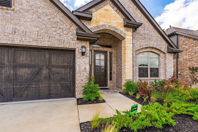 2603 Loxley Dr, Mansfield, TX 76084 - entrance to property with an attached garage, brick siding, driveway, and stone siding
