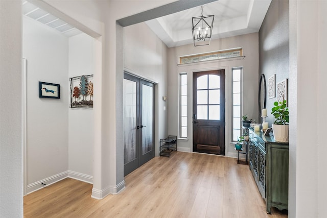 2603 Loxley Dr, Mansfield, TX 76084 - entryway with light wood finished floors, a chandelier, baseboards, a tray ceiling, and a high ceiling