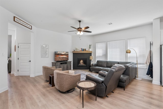 2603 Loxley Dr, Mansfield, TX 76084 - living area with light wood finished floors, ceiling fan, baseboards, and a warm lit fireplace