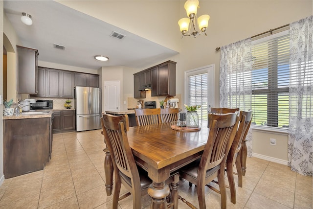 4013 Vista Greens Dr, Fort Worth, TX 76244 - dining area featuring a chandelier, light tile patterned flooring, and baseboards