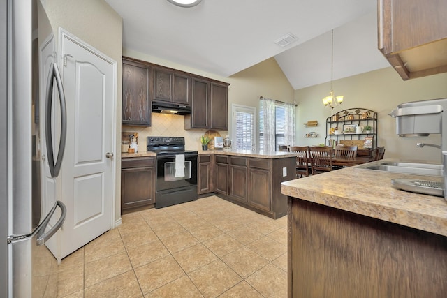 4013 Vista Greens Dr, Fort Worth, TX 76244 - kitchen featuring black electric range oven, under cabinet range hood, freestanding refrigerator, lofted ceiling, and light tile patterned floors