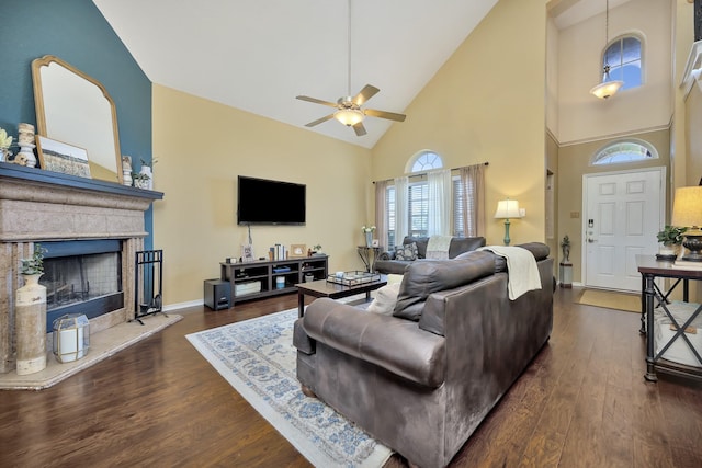 4013 Vista Greens Dr, Fort Worth, TX 76244 - living area featuring high vaulted ceiling, a ceiling fan, dark wood finished floors, a fireplace with raised hearth, and baseboards