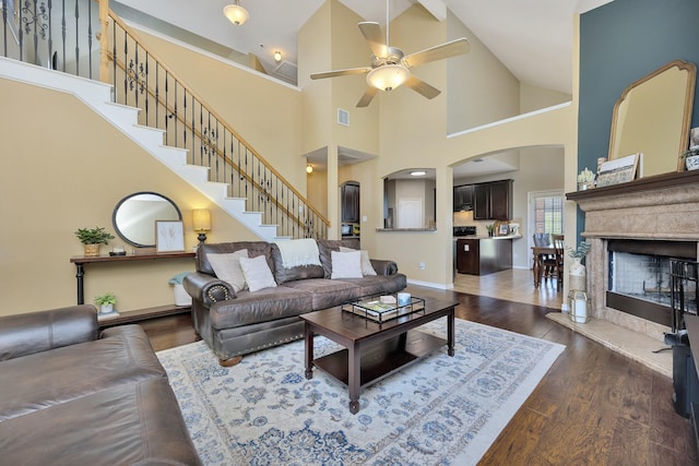 4013 Vista Greens Dr, Fort Worth, TX 76244 - living room featuring a ceiling fan, arched walkways, high vaulted ceiling, wood finished floors, and stairs