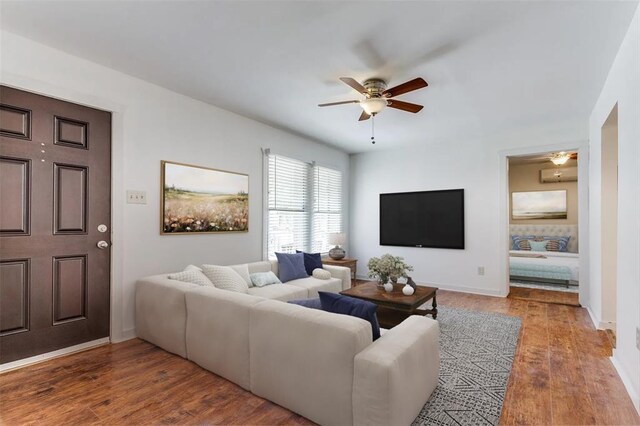 3901 Winfield Ave, Fort Worth, TX 76109 - living area featuring ceiling fan, wood finished floors, an AC wall unit, and baseboards