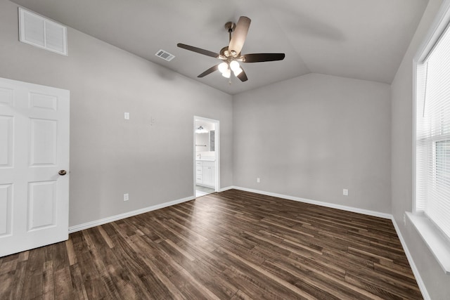 209 NE 6th Ave, Mineral Wells, TX 76067 - unfurnished bedroom with vaulted ceiling, dark wood-style flooring, baseboards, a ceiling fan, and ensuite bathroom