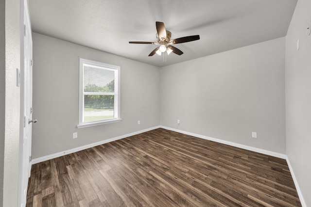 209 NE 6th Ave, Mineral Wells, TX 76067 - unfurnished room with dark wood-style floors, a ceiling fan, and baseboards