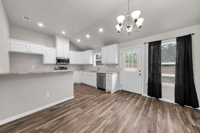 209 NE 6th Ave, Mineral Wells, TX 76067 - kitchen featuring stainless steel appliances, a chandelier, dark wood-type flooring, white cabinets, and a sink