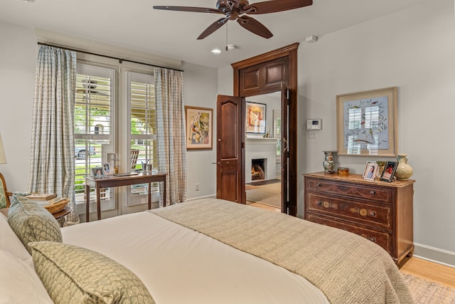 3766 W 4th St, Fort Worth, TX 76107 - bedroom with baseboards, light wood-style floors, a lit fireplace, a ceiling fan, and recessed lighting