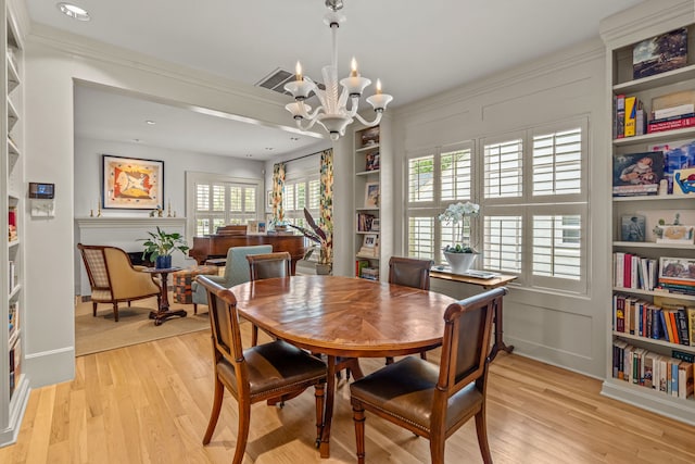 3766 W 4th St, Fort Worth, TX 76107 - dining area featuring light wood-type flooring, a chandelier, and built in shelves