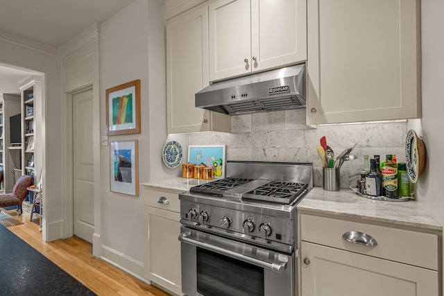 3766 W 4th St, Fort Worth, TX 76107 - kitchen featuring under cabinet range hood, high end stainless steel range oven, tasteful backsplash, and light stone countertops