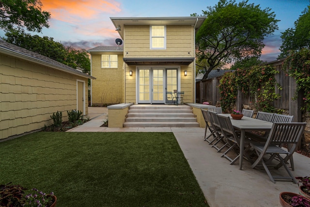 3766 W 4th St, Fort Worth, TX 76107 - back of property at dusk with french doors, a patio area, and entry steps