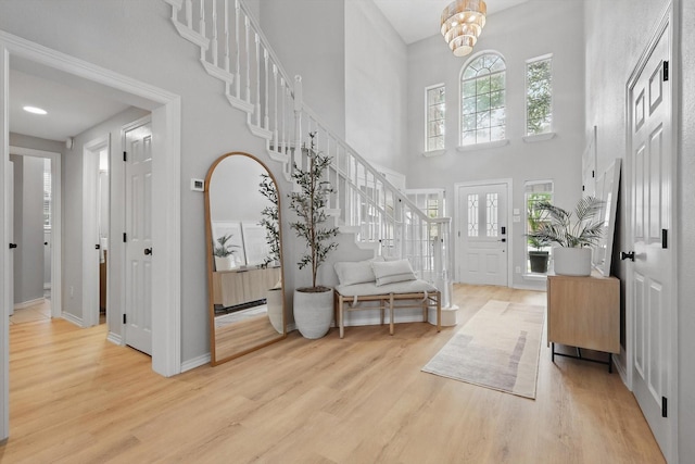 7205 Fair Valley Way, Plano, TX 75024 - foyer entrance featuring light wood-type flooring, stairs, a high ceiling, and baseboards