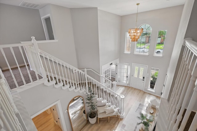 7205 Fair Valley Way, Plano, TX 75024 - foyer entrance featuring a high ceiling, stairs, wood finished floors, and plenty of natural light