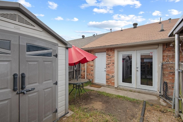 31 W Townhouse Ln Unit 20, Grand Prairie, TX 75052 - entrance to property featuring french doors, a shingled roof, and brick siding