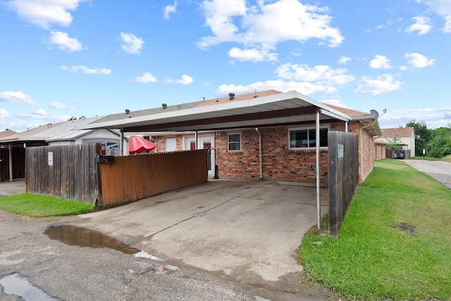 31 W Townhouse Ln Unit 20, Grand Prairie, TX 75052 - back of property with brick siding and a carport