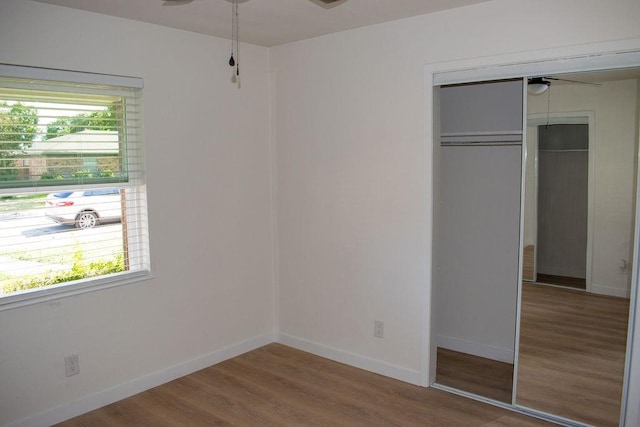 731 E Cherry St, Duncanville, TX 75116 - unfurnished bedroom featuring wood finished floors, a closet, and baseboards