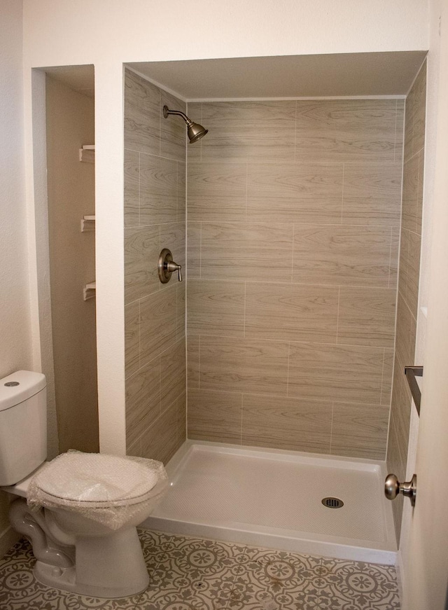 731 E Cherry St, Duncanville, TX 75116 - bathroom featuring tile patterned flooring, a shower stall, and toilet