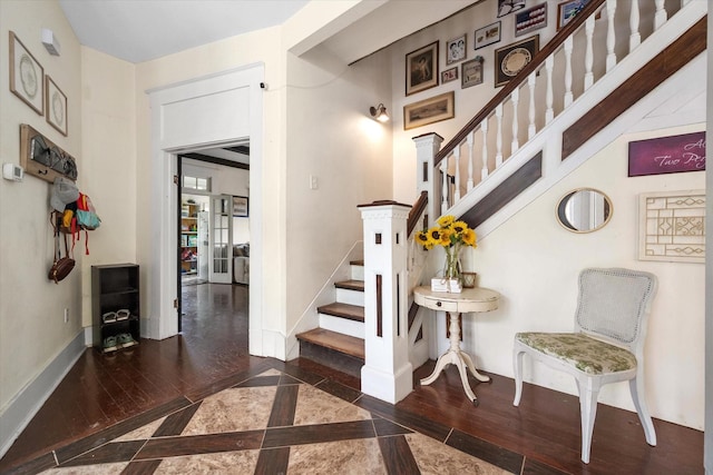 100 Corsicana St, Hillsboro, TX 76645 - staircase with wood finished floors, inlaid floor details, and baseboards