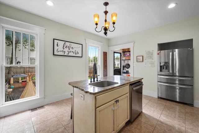 100 Corsicana St, Hillsboro, TX 76645 - kitchen featuring appliances with stainless steel finishes, a sink, a chandelier, baseboards, and light tile patterned floors