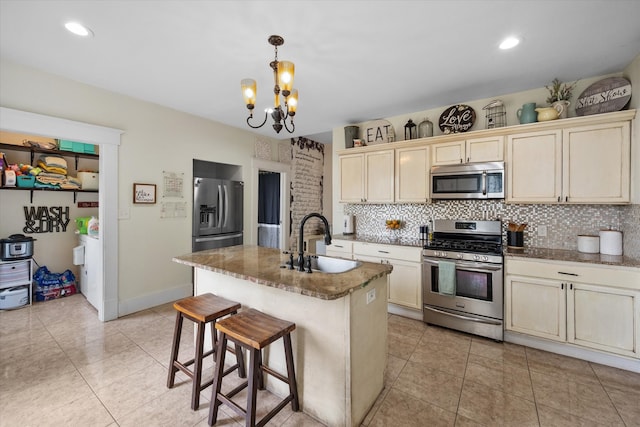 100 Corsicana St, Hillsboro, TX 76645 - kitchen with stainless steel appliances, a sink, backsplash, and a chandelier