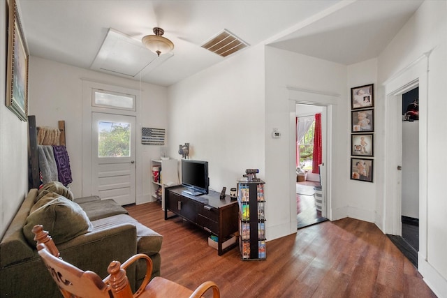 100 Corsicana St, Hillsboro, TX 76645 - living room featuring attic access, healthy amount of natural light, and wood finished floors