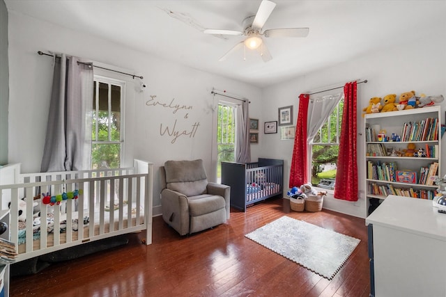 100 Corsicana St, Hillsboro, TX 76645 - bedroom with wood finished floors, a crib, and a ceiling fan