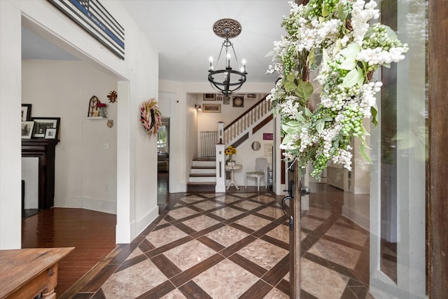 100 Corsicana St, Hillsboro, TX 76645 - foyer entrance with inlaid floor details, a chandelier, stairs, and baseboards