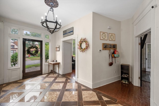 100 Corsicana St, Hillsboro, TX 76645 - entrance foyer featuring a chandelier, inlaid floor details, and baseboards