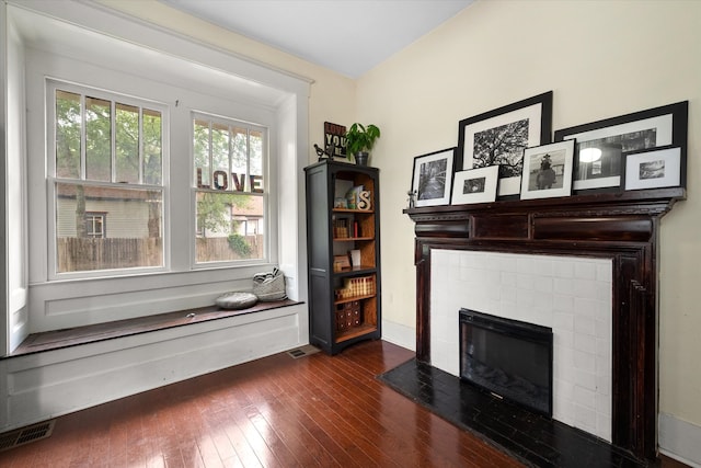 100 Corsicana St, Hillsboro, TX 76645 - living area featuring dark wood-type flooring and a tile fireplace