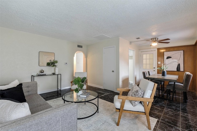3406 Schwartz Ave, Fort Worth, TX 76106 - living room with arched walkways, a textured ceiling, and a ceiling fan