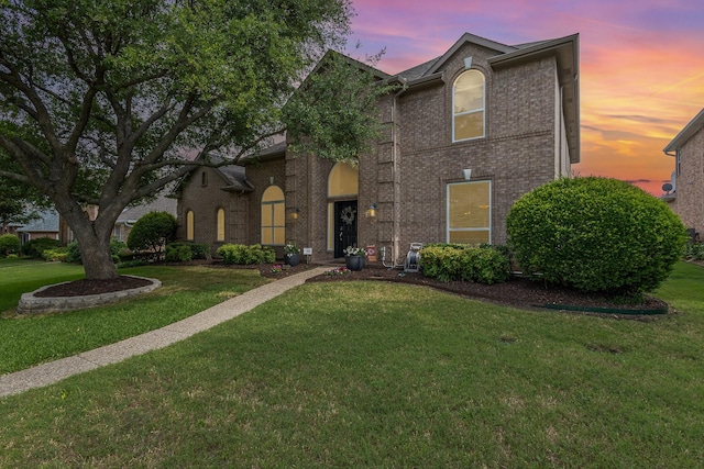 2916 Woods Dr, Plano, TX 75025 - traditional-style house featuring a front yard and brick siding