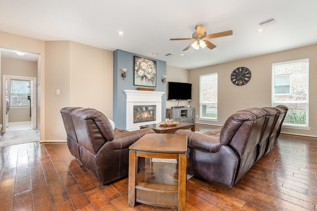 2916 Woods Dr, Plano, TX 75025 - living room with a glass covered fireplace, dark wood-style flooring, a ceiling fan, plenty of natural light, and recessed lighting