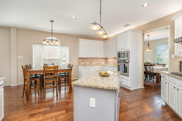 2916 Woods Dr, Plano, TX 75025 - kitchen featuring appliances with stainless steel finishes, recessed lighting, dark wood-style flooring, white cabinets, and backsplash