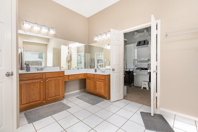2916 Woods Dr, Plano, TX 75025 - full bathroom featuring double vanity, tile patterned flooring, baseboards, and a walk in closet