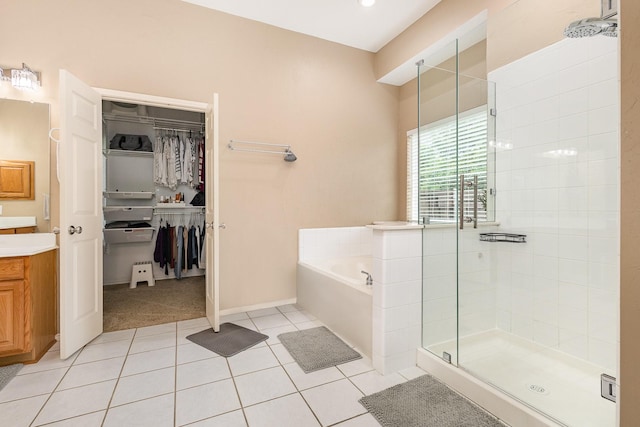 2916 Woods Dr, Plano, TX 75025 - full bath featuring a stall shower, tile patterned flooring, vanity, a bath, and a spacious closet