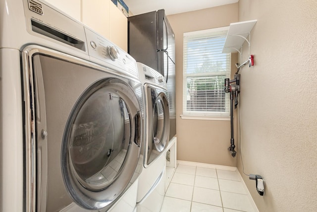 2916 Woods Dr, Plano, TX 75025 - washroom with washing machine and dryer, tile patterned floors, and baseboards