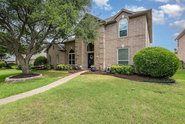 2916 Woods Dr, Plano, TX 75025 - traditional home with brick siding and a front yard
