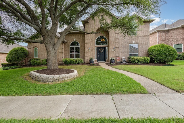 2916 Woods Dr, Plano, TX 75025 - traditional-style home featuring a front lawn and brick siding