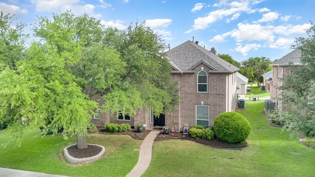 2916 Woods Dr, Plano, TX 75025 - view of front of house featuring central air condition unit and a front lawn