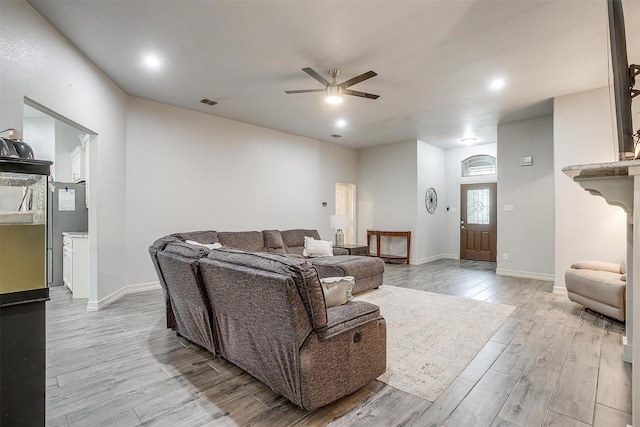 1017 Thistle Hill Trl, Weatherford, TX 76087 - living room with light wood finished floors, a ceiling fan, and baseboards