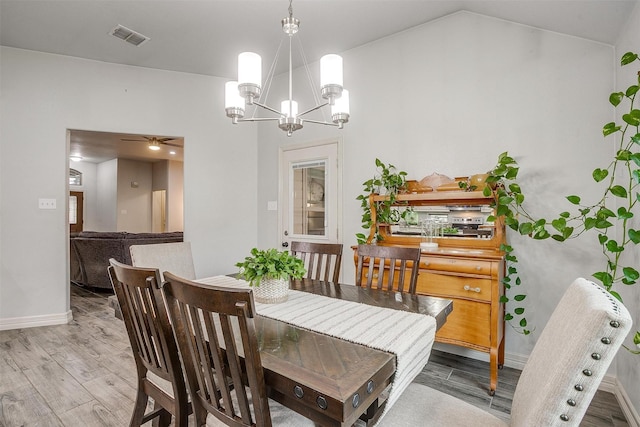 1017 Thistle Hill Trl, Weatherford, TX 76087 - dining room with wood finished floors, a chandelier, baseboards, and ceiling fan